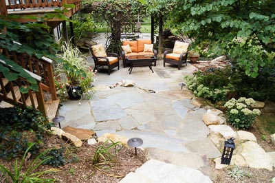 Patio with Chairs and lots of flowers
